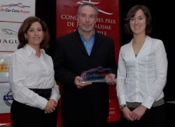 Katherine Power (L), Manager of Public Relations, Car Care Canada and Rachel LePage (R), Public Affairs Coordinator, Automotive Industries Association of Canada, present Jeremy Cato with the Car Care Canada Award for Safety Journalism. Photo courtesy AJAC/Arne Glassbourg.