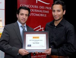 Anthony Paulozza (L), Marketing Manager of Pirelli, presents 1st Runner Up Amee Reehal with the Pirelli Photography Award, Published. Photo courtesy AJAC/Arne Glassbourg. 